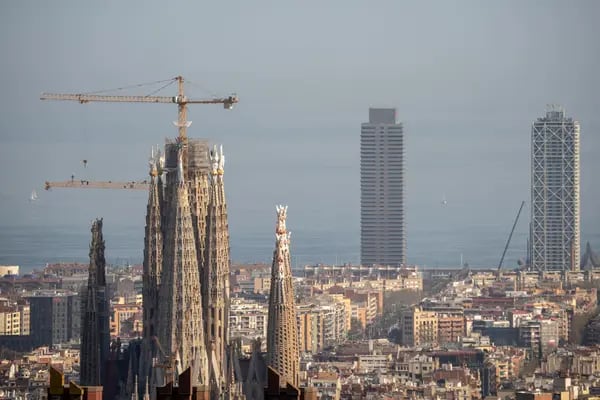 Construction cranes by the Sagrada Familia cathedral on the city skyline in Barcelona, Spain on Friday, March 22, 2024. In Barcelona’s designated stressed residential market areas, new tenants are now entitled to a rent level no higher than the last lease agreement from the previous five years. Photographer: Manaure Quintero/Bloomberg