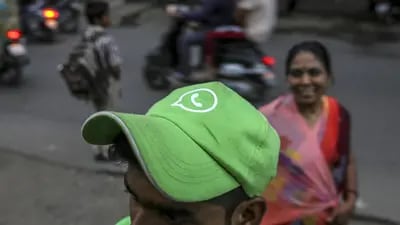 A WhatsApp ambassador wears a branded cap during a roadshow for Facebook Inc.'s WhatsApp messaging service and Reliance Jio Infocomm Ltd.'s wireless network in Pune, India, on Thursday, Oct. 25, 2018. Facebook and Reliance Jio are teaming up to draw hordes of customers with cheap phones, rock-bottom rates and handy messaging services. Photographer: Dhiraj Singh/Bloomberg