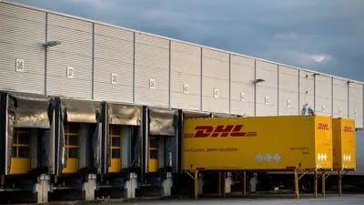 DHL delivery wagons in the loading bay at a Deutsche Post AG sorting office in Berlin, Germany.