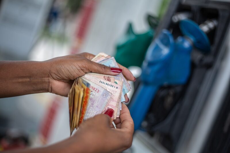 An employee counts bills at a Petroleo Brasileiro SA (Petrobras) gas station in Rio de Janeiro, Brazil.