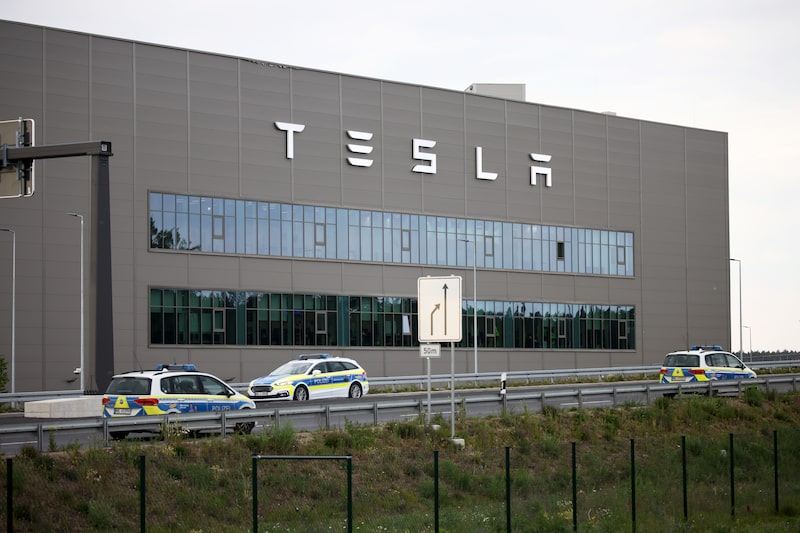 Police cars patrol outside the Tesla Inc. factory, the night before a demonstration against its expansion, in Gruenheide, Germany, on Friday, May 10, 2024. Tesla's German factory has long experienced pushback from disgruntled locals and environmental groups.