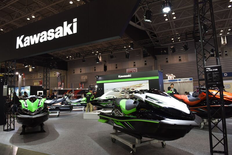 A Kawasaki Motors Japan Co. jet Ultra 310R jet ski, front middle, stands on display with other jet skis at the Japan International Boat Show in Yokohama