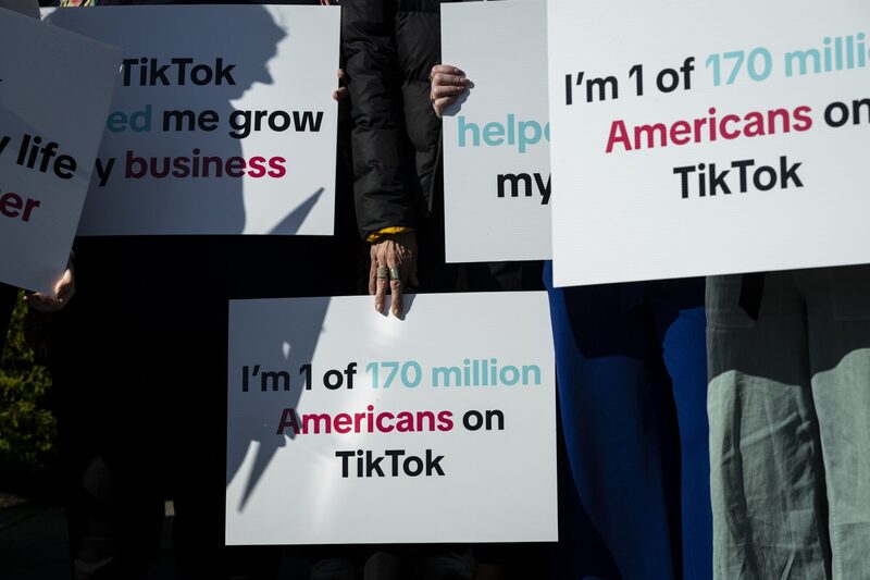A group of Tik Tok creators and advocates hold signs before a news conference outside the US Capitol in Washington, DC, US, on Tuesday, March 12, 2024