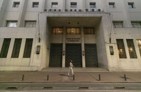 A pedestrian walks past the Montevideo Stock Exchange (BVM) in Montevideo, Uruguay, on Wednesday, April 10, 2019. Uruguay's 152-year old bourse is considering a bid for its emblematic headquarters in Montevideo's historic financial district as it looks to cut costs. Photographer: Tali Kimelman/Bloomberg